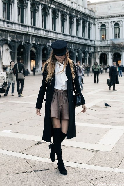 With white button down blouse, gray high-waisted shorts, black leather chain strap bag and black suede over the knee low heeled boots