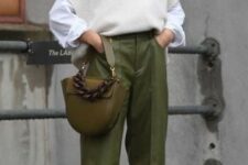 With white button down loose shirt, black leather high boots and olive green leather bag