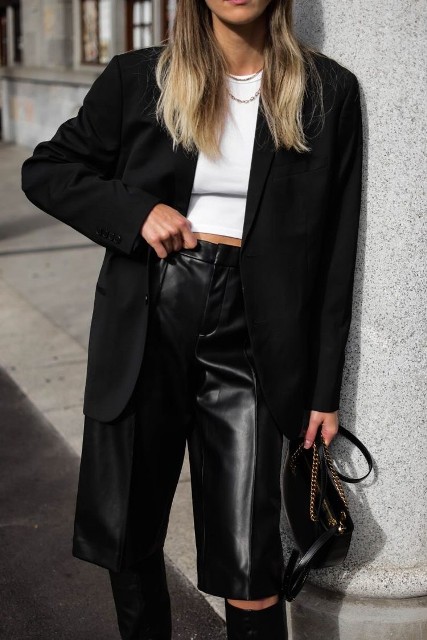 With white crop top, necklace, black leather mini bag and black suede high boots