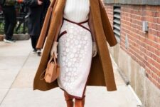 With white turtleneck, white and brown high-waisted wrap midi skirt, brown leather bag and brown leather high boots