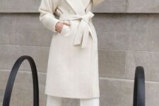 With white turtleneck, white culottes and white leather mid calf boots