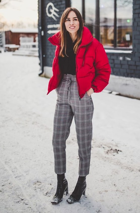 a black sweater, grey plaid cropped pants, black heeled boots, a hot red cropped puffer jacket