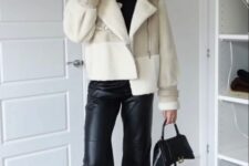 a black t-shirt, leather pants and boots, a small bag, a neutral cropped shearling jacket and a grey beanie