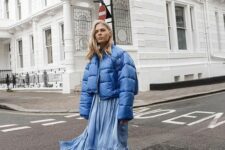 a blue cropped puffer jacket, a blue midi dress, black lacquer boots for a chic and stylish winter look