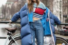 a blue oversized puffer coat with a metallic lining looks wow in this layered look