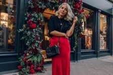 a chic look with a black top with a high neckline, a red slip midi skirt, a black bag and shoes for the holidays