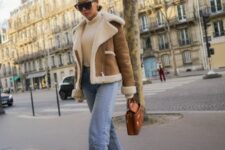 a creamy turtleneck, light blue jeans, mustard suede boots, a cropped sherling jacket and a brown bag