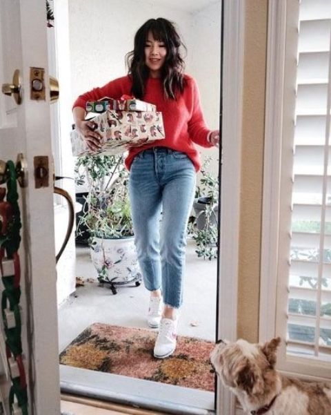 a lovely Christmas look with a red sweater, blue jeans and white sneakers is an ideal casual solution