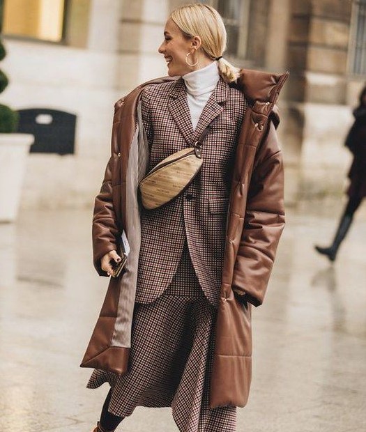 a plaid skirt suit, a white turtleneck, a waistbag, a brown leather puffer coat for a winter work look