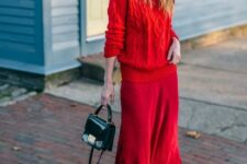 a red braided sweater, a deep red midi skirt, grey booties and a small black bag for a super chic winter look
