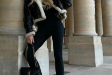 a sport chic winter outfit with a black turtleneck and leggings, white trainers and socks, a cropped shearling jacket and a black bag