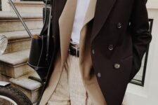 a stylish layered winter wotk outfit with a white t-shirt, neutral trousers, a tan blazer, a black cropped coat and a black bag