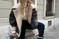 a stylish monochromatic winter look with a neutral jumper, black leggings and boots plus a cropped shealring