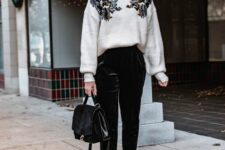 a white embroidered sweater, black velvet pants, white shoes and a black bag plus statement earrings are a nice Christmas work look