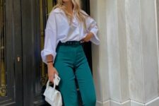 a white shirt, green high waisted pants, white shoes and a small white bag are a lovely outfit for casual Christmas