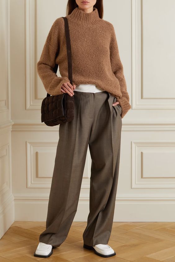 a white t-shirt, a camel boucle turtleneck sweater, grey trousers, white boots and  a brown bag for winter
