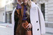 With beige beret, white coat, rounded sunglasses, brown and blue striped shirt, brown leather mini bag and brown leather gloves