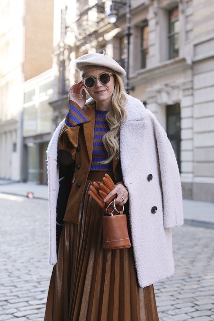 With beige beret, white coat, rounded sunglasses, brown and blue striped shirt, brown leather mini bag and brown leather gloves
