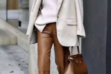With beige loose turtleneck sweater, brown leather bag, sunglasses and brown suede pumps