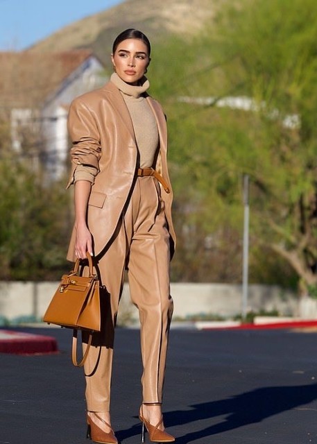 With beige turtleneck, brown leather belt, bown leather bag and brown leather shoes