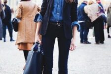 With denim button down shirt, belt, blue leather tote bag and black patent leather boots