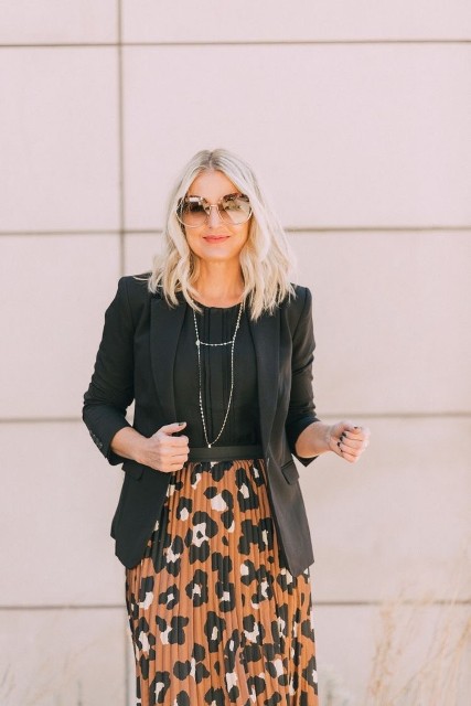 With oversized sunglasses, black blouse and silver necklace