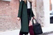 With purple wide brim hat, white shirt, printed scarf, emerald green midi trench coat and black leather tote bag