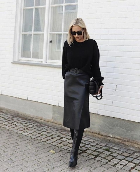 With sunglasses, black sweater, black belt and black leather bag
