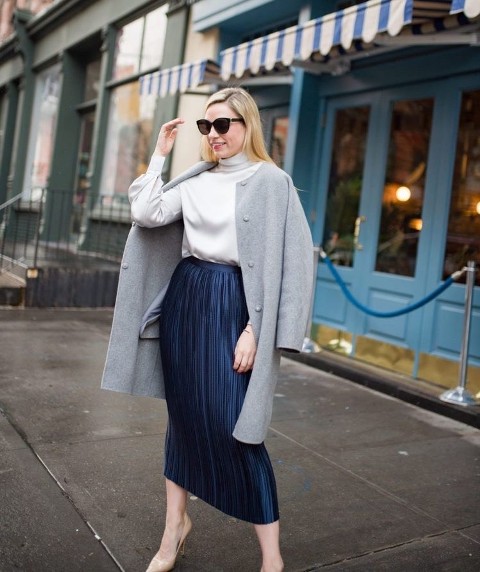 With sunglasses, gray collarless knee length coat and beige leather pumps