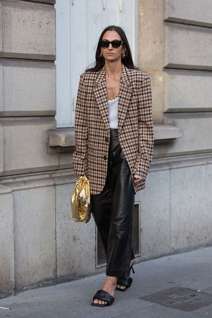 With sunglasses, rounded earrings, white top, golden necklace, golden clutch and black leather mules