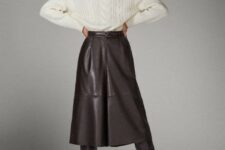 With white knitted turtleneck sweater and leather belt