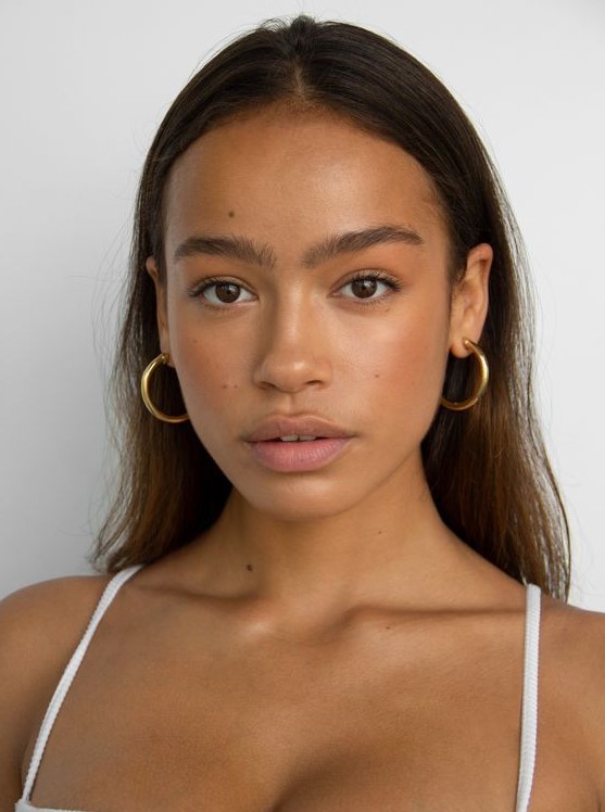a clean girl makeup with a matte nude lip, a touch of blush, fluffy eyebrows and naturally glowy skin