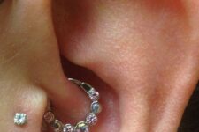 a daith and double tragus piercing done with studs and a hoop with rhinestones are a lovely combo