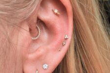 a double lobe, daith, flat and triple mid helix piercing done with rhinesotne studs and hoops are amazing