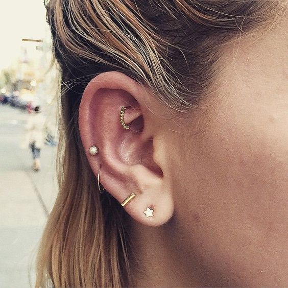 a double lobe, mid helix and rook piercing with gold studs and hoops with rhinestones look amazing