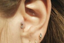 a double tragus and triple lobe piercing done with studs and rhinestone hoops is a lovely idea