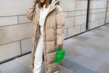 a neutral winter look with a white sweatshirt and sweatpants, white sneakers and socks, a bold green beanie and a bag