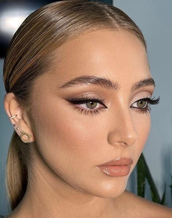 a siren eye makeup with a touch of blush, a glossy nude lip, sire eyes, fluffy eyebrows is amazing