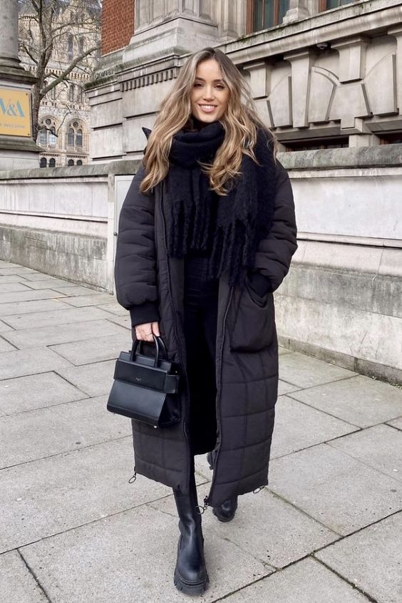 a total black winter look with a sweater, jeans, chunky boots, a puffer coat, a scarf and a bag is always a good idea