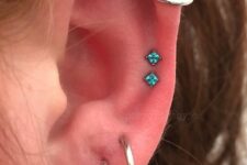 a triple lobe, double mid helix and helix piercing done with white gold hoops and turquoise studs are amazing