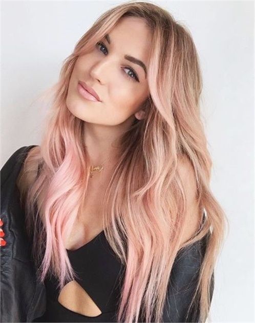 beachy blonde hair with pastel pink locks, with waves, curtain bangs is a gorgeous idea to play with colors