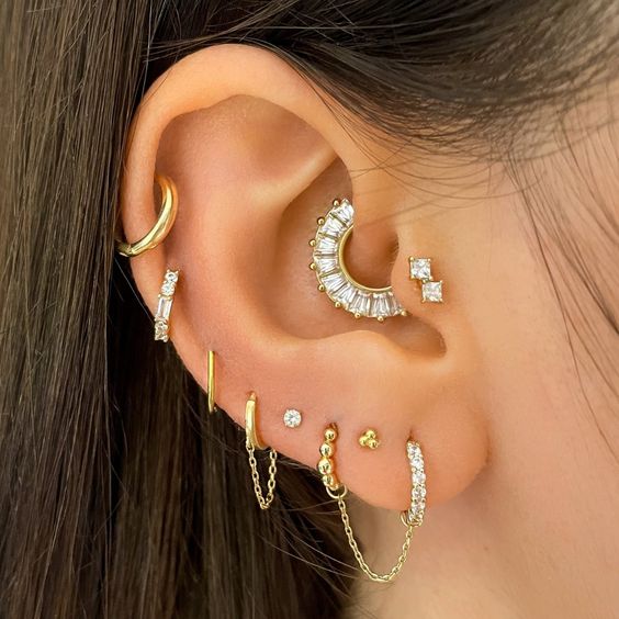 beautiful and bold ear styling with a multiple lobe, helix, daith and double tragus piercing, with hoops and studs