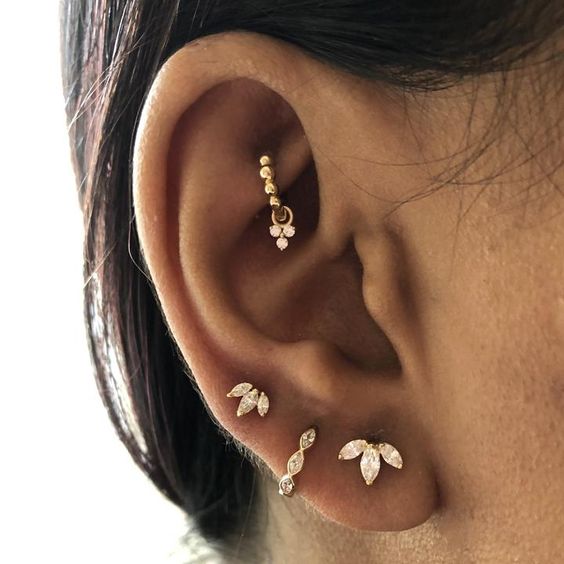 bold ear styling done with stacked lobe, high lobe, rook piercings with beautiful and chic studs and hoops