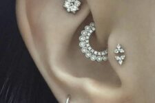 bold ear styling with a triple lobe, daith, faux rook and double tragus piercing, with hoopes and studs
