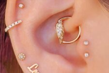 fabulous ear styling with multiple lobe, flat and helix, double tragus and daith piercings, with studs, hoops and a word earring