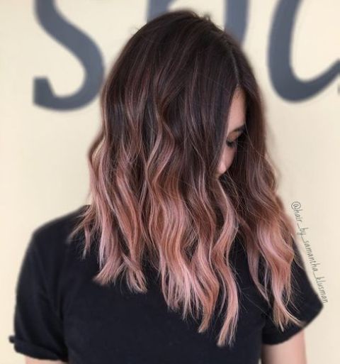 long wavy hair with a dark root and strawberry pink balayage is a fantastic idea with much contrast