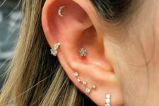 lovely ear styling with a lobe, high lobe, helix, flat and conch piercing done with hoops and studs of various shapes