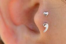 minimalist and fun ear styling with a double tragus and lobe piercing with a semi colon and a bold blue stud