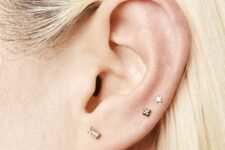 minimalist ear styling with a lobe and double mid helix piercing done with cool studs is amazing