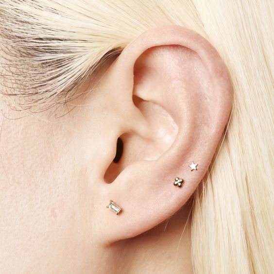 minimalist ear styling with a lobe and double mid helix piercing done with cool studs is amazing